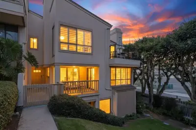 a house with a sunset in the background at Beachfront feat Private Den SS166 in Solana Beach