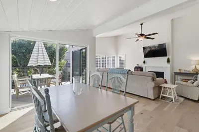 a living room with a table and a couch at Beachfront feat Private Den SS166 in Solana Beach