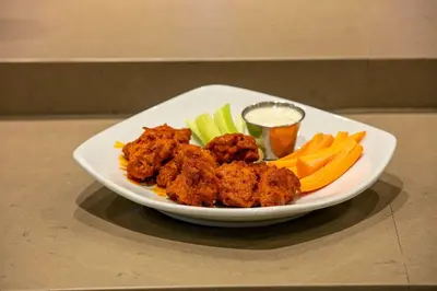 a plate of food with meat and vegetables on a table at Country Inn & Suites by Radisson, San Diego North, CA in Mira Mesa