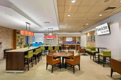 a dining area with tables and chairs in a restaurant at Country Inn & Suites by Radisson, San Diego North, CA in Mira Mesa