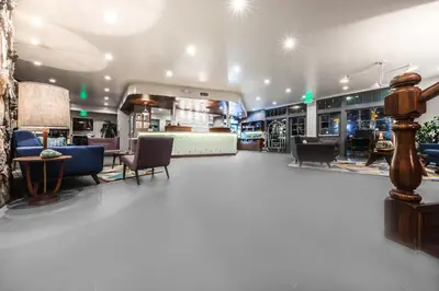 a lobby of a store with chairs and tables at Kings Inn in San Diego