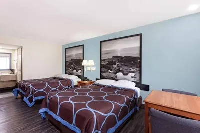 a hotel room with two beds and a desk at Super 8 by Wyndham El Cajon San Diego in El Cajon