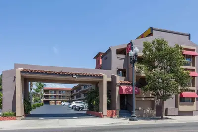 a building with an archway in front of a street at Super 8 by Wyndham El Cajon San Diego in El Cajon