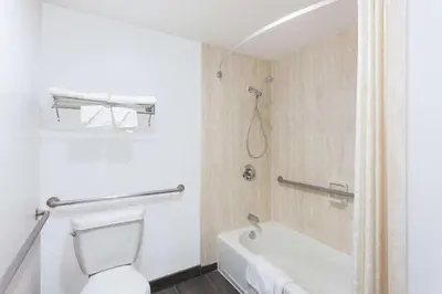 a bathroom with a toilet and a bath tub at Super 8 by Wyndham El Cajon San Diego in El Cajon