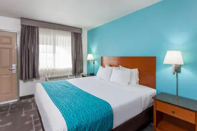 a hotel room with a large bed and a window at Howard Johnson by Wyndham National City/San Diego South in National City
