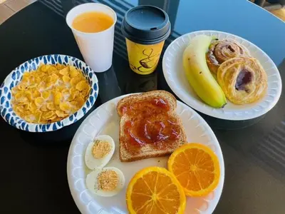 three plates of breakfast foods on a table at Days Inn by Wyndham San Diego-East/El Cajon in El Cajon