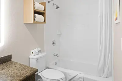 a bathroom with a white toilet and a shower at Days Inn by Wyndham San Diego-East/El Cajon in El Cajon