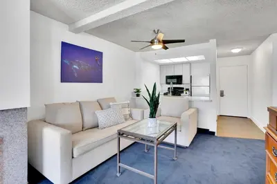 a living room with a couch and a table at Oceanside Marina Suites - A Waterfront Hotel in Oceanside