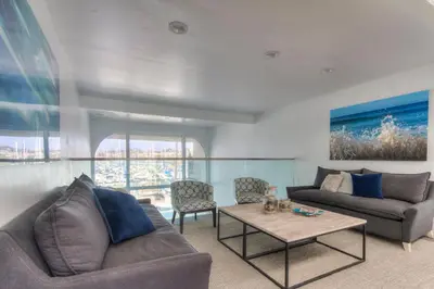 a living room with a couch and a table at Oceanside Marina Suites - A Waterfront Hotel in Oceanside