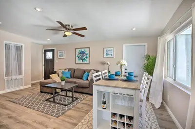 a living room with a couch and a ceiling fan at Chic Central San Diego House with Private Pool! in San Diego