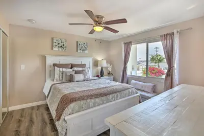 a bedroom with a bed and a ceiling fan at Chic Central San Diego House with Private Pool! in San Diego