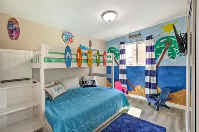 a bedroom with a bed and surfboards on the wall at Chic Central San Diego House with Private Pool! in San Diego