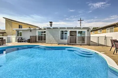 a large blue swimming pool in front of a house at Chic Central San Diego House with Private Pool! in San Diego