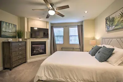 a bedroom with a bed with a ceiling fan and a fireplace at Sunny San Diego Escape Less Than 2 Miles to Pacific Beach! in San Diego