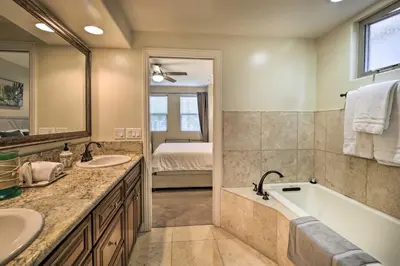a bathroom with a tub and a sink and a bath tub at Sunny San Diego Escape Less Than 2 Miles to Pacific Beach! in San Diego