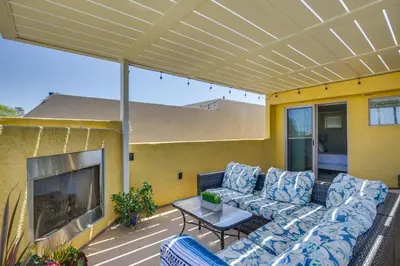 a patio with a couch and a fire place at Sunny San Diego Escape Less Than 2 Miles to Pacific Beach! in San Diego