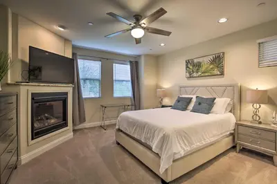 a bedroom with a bed with a ceiling fan and a fireplace at Sunny San Diego Escape Less Than 2 Miles to Pacific Beach! in San Diego