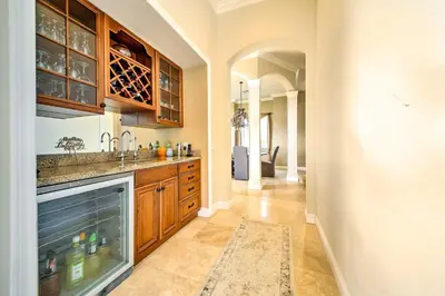 a kitchen with wooden cabinets and a sink at Luxe Wine Country Estate with Orchard-Facing Balcony in Temecula