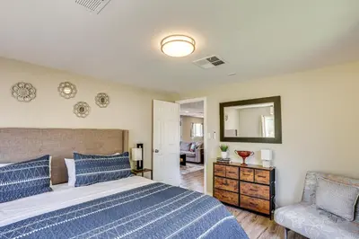 a bedroom with a bed and a chair and a mirror at Escondido Vineyard Estate Walk to Wineries! in Escondido