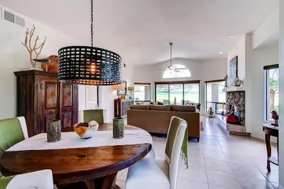 a dining room and living room with a wooden table at Country Club Home 2 BR, 2 BA and Den about 1 Mi to Golf in Borrego Springs
