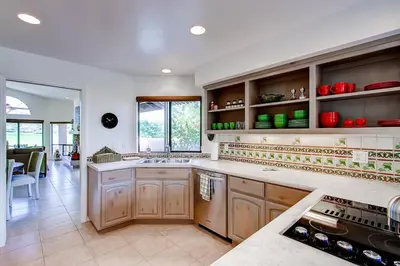 a large kitchen with wooden cabinets and a counter top at Country Club Home 2 BR, 2 BA and Den about 1 Mi to Golf in Borrego Springs