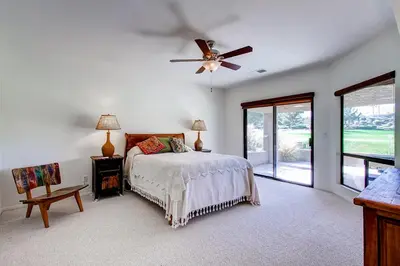 a bedroom with a bed and a ceiling fan at Country Club Home 2 BR, 2 BA and Den about 1 Mi to Golf in Borrego Springs