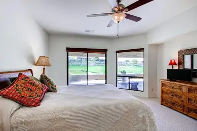 a bedroom with a bed and a ceiling fan at Country Club Home 2 BR, 2 BA and Den about 1 Mi to Golf in Borrego Springs
