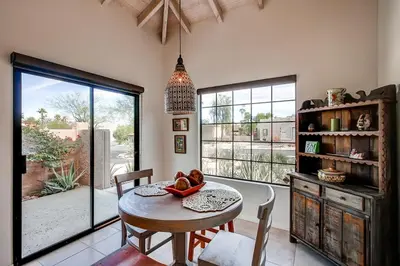 a dining room with a table and a large window at Country Club Home 2 BR, 2 BA and Den about 1 Mi to Golf in Borrego Springs