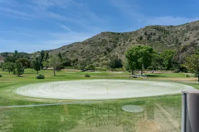 a golf course with mountains in the background at Pala Mesa Resort in Fallbrook