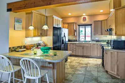 a kitchen with a island with two chairs in it at Borrego Springs Home with Desert and Mountain Views! in Borrego Springs