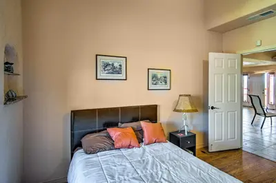 a bedroom with a bed and a table with a lamp at Borrego Springs Home with Desert and Mountain Views! in Borrego Springs