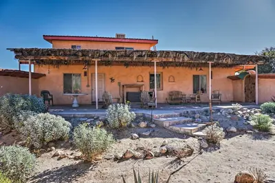 a house with a patio in front of it at Borrego Springs Home with Desert and Mountain Views! in Borrego Springs