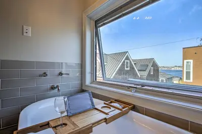 a bathroom with a tub and a large window at San Diego Home - Walk to Sail Bay and Mission Beach! in San Diego