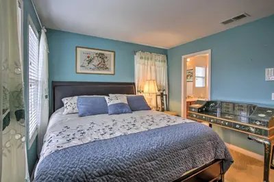 a bedroom with a bed with blue walls at Luxe San Diego Getaway with Pool and Ocean Views in San Diego