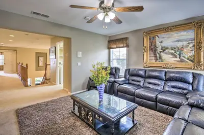 a living room with a couch and a ceiling fan at Luxe San Diego Getaway with Pool and Ocean Views in San Diego