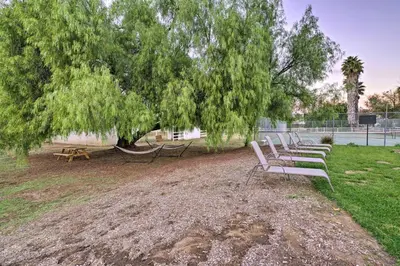 a row of park benches sitting under a tree at Family Retreat - Private Tennis Court and Game Room in Valley Center