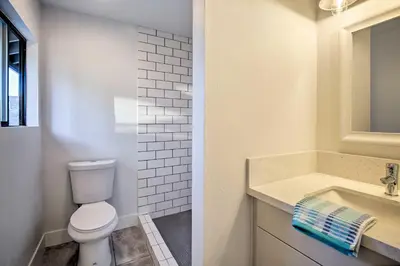 a bathroom with a toilet and a sink at Family Retreat - Private Tennis Court and Game Room in Valley Center