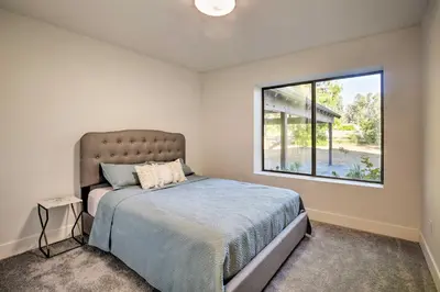 a bedroom with a bed and a window at Family Retreat - Private Tennis Court and Game Room in Valley Center