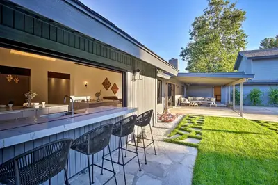 a backyard with a bar with chairs and a lawn at Family Retreat - Private Tennis Court and Game Room in Valley Center