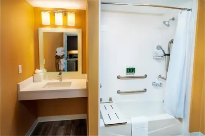 a bathroom with a tub and a sink and a shower at TownePlace Suites Irvine Lake Forest in Lake Forest