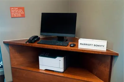 a desk with a computer monitor and a printer on it at TownePlace Suites Irvine Lake Forest in Lake Forest