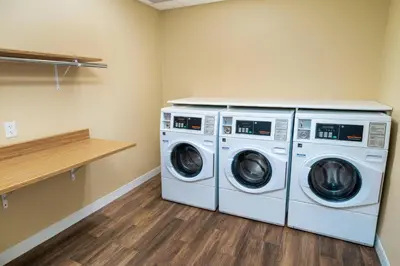 a laundry room with two washer and dryer at TownePlace Suites Irvine Lake Forest in Lake Forest