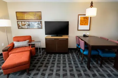 a hotel room with a desk and a television at TownePlace Suites Irvine Lake Forest in Lake Forest