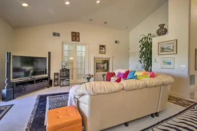 a living room with a couch and a flat screen tv at El Cajon Home with Pool, Grill Station and Decks in El Cajon