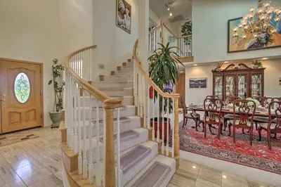 a staircase in a home with a table and a dining room at El Cajon Home with Pool, Grill Station and Decks in El Cajon