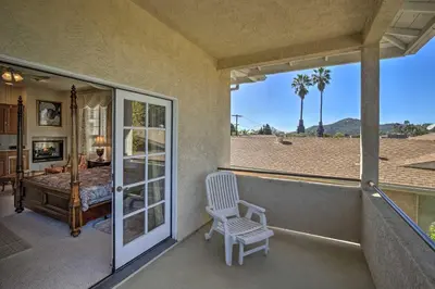 a porch with a chair and a bedroom with a view at El Cajon Home with Pool, Grill Station and Decks in El Cajon