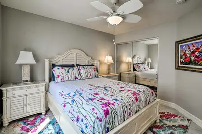 a bedroom with a bed and a ceiling fan at Oceanside Home with Rooftop Patio, Walk to Beach! in Oceanside