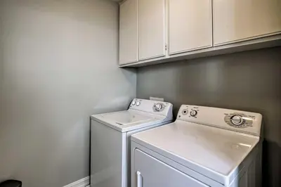 a small laundry room with a washer and dryer at Oceanside Home with Rooftop Patio, Walk to Beach! in Oceanside