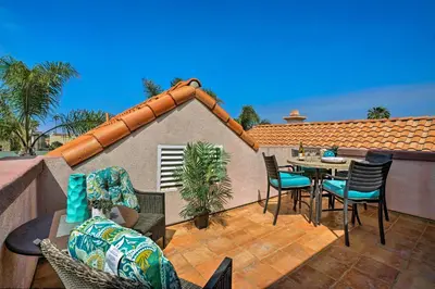 a patio with a table and chairs on a balcony at Oceanside Home with Rooftop Patio, Walk to Beach! in Oceanside