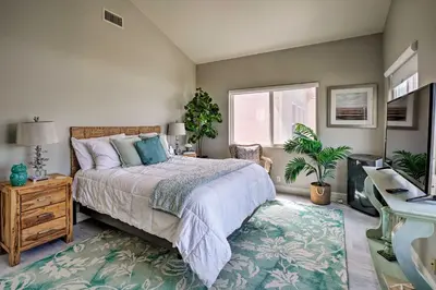 a bedroom with a bed and a desk and a window at Oceanside Home with Rooftop Patio, Walk to Beach! in Oceanside